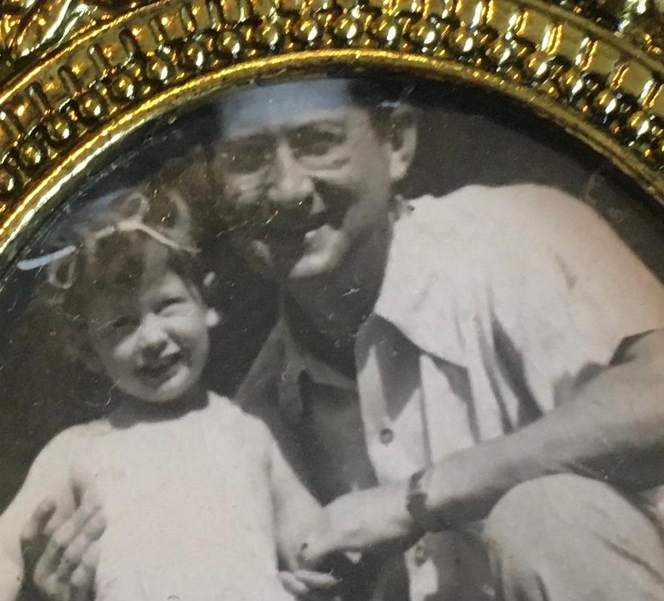 Miriam and her father in black and white photo in gold frame