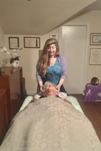 Miriam performing Reiki on a client