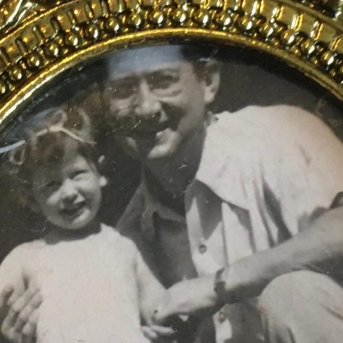 Miriam and her father in black and white photo in gold frame